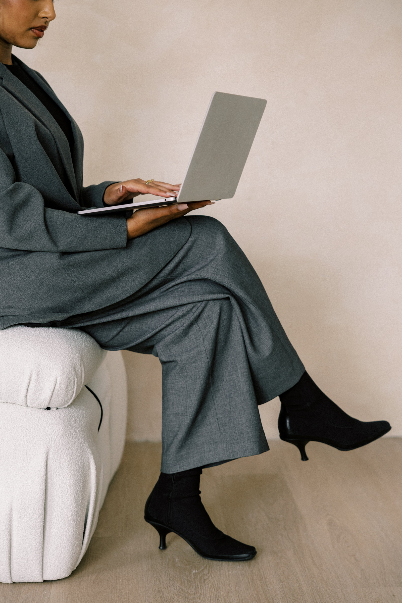 A therapist sitting at a desk, looking concerned while on a video call, with a frozen client screen and poor connection symbols, representing the challenges of telehealth therapy.